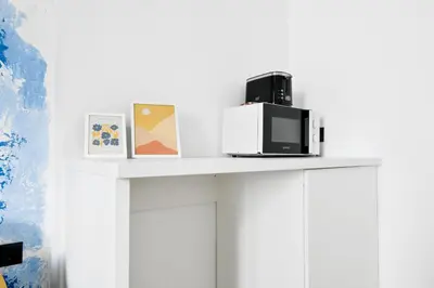 a white shelf with a microwave on top of it at 2 Private Suits - Art, Location, Quiet, Balconies in Sofia