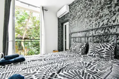 a bedroom with a zebra print bed with a window at 2 Private Suits - Art, Location, Quiet, Balconies in Sofia