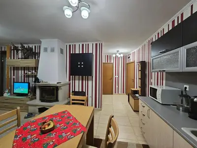a kitchen with a table and a dining room at Частен Апартамент Пампорово Гранд Манастира 2Б5 in Pamporovo