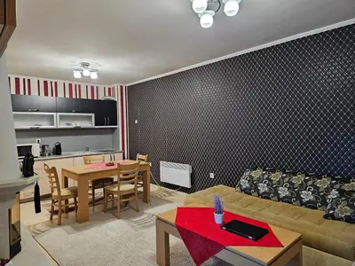a living room with a couch and a table at Частен Апартамент Пампорово Гранд Манастира 2Б5 in Pamporovo