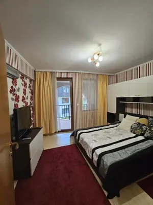 a bedroom with a bed and a flat screen tv at Частен Апартамент Пампорово Гранд Манастира 2Б5 in Pamporovo