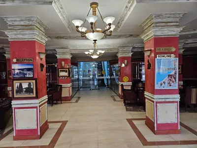 a hallway with columns and a chandelier in a building at Частен Апартамент Пампорово Гранд Манастира 2Б5 in Pamporovo