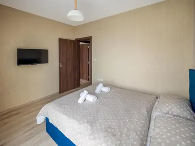 a bedroom with a bed with two towels on it at The Boulevard Luxury Apartment 2 in Sofia