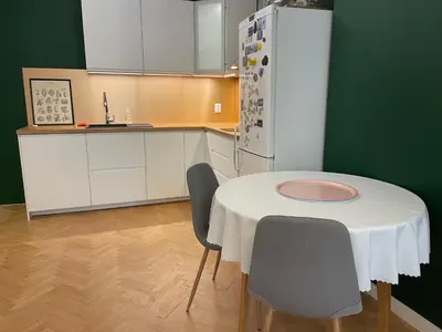 a kitchen with a table and two chairs and a refrigerator at Levski studio at heart of Sofia in Sofia