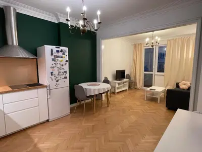 a kitchen and living room with a refrigerator and a table at Levski studio at heart of Sofia in Sofia