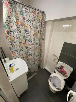 a bathroom with a toilet and a sink and a shower curtain at Levski studio at heart of Sofia in Sofia