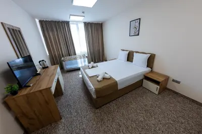 a hotel room with a bed and a television at City Plaza in Botevgrad