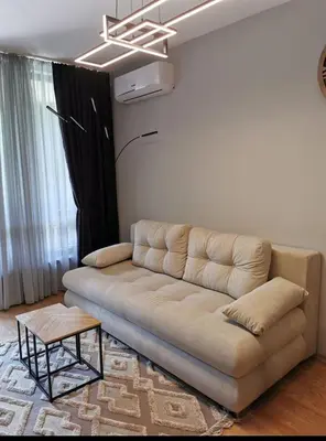 a living room with a couch and a table at Aspen Suites Luxury apartment A005 in Razlog