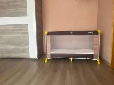 a small bed in a room next to a door at Къща Росена - стаи за гости in Devin