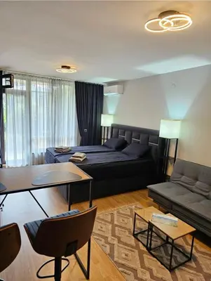 a living room with a couch and a table at Aspen Suites Luxury Studio A006 in Razlog