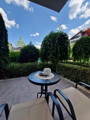 a table and chairs sitting on a patio at Aspen Suites Luxury Studio A006 in Razlog