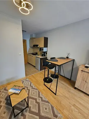 a living room with a table and a kitchen at Aspen Suites Luxury Studio A006 in Razlog