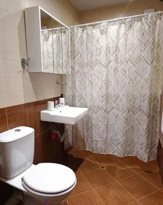 a bathroom with a toilet and a sink and a shower at Mladost Sofia, close to Metro Station and Center in Sofia