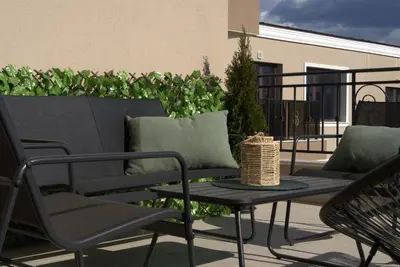 a patio with chairs and a table on a balcony at Panorama view free parking in Sofia