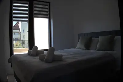 a bed in a room with a large window at Panorama view free parking in Sofia