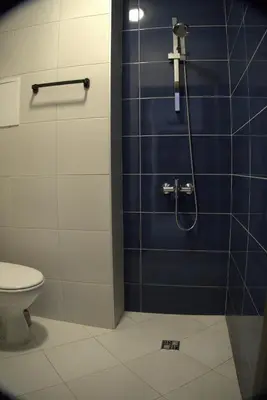 a bathroom with a shower with a toilet at Panorama view free parking in Sofia