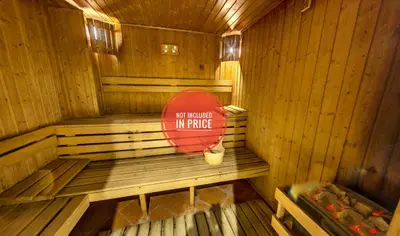 a wooden sauna with a sign in the middle at Belvedere Holiday Club K106 in Bansko
