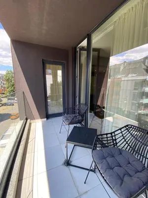 a balcony with two chairs and chairs on a building at Gran Capital - Mountain View, FREE Parking in Sofia