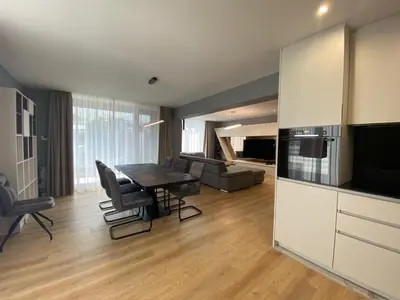 a kitchen and living room with a table and chairs at Gran Capital - Mountain View, FREE Parking in Sofia