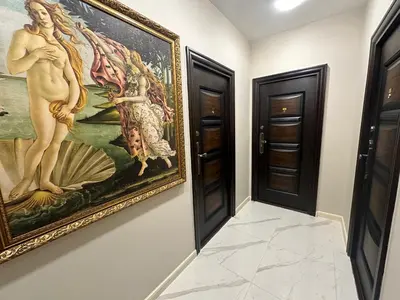 a painting hanging on a wall next to two doors at Luxury Apartments 1 in Sofia