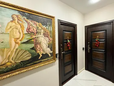 a painting hanging on a wall next to two doors at Luxury Apartments 1 in Sofia