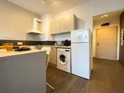 a kitchen with a white refrigerator and a dishwasher at BOOK High Rise Studio by Cosher in Sofia
