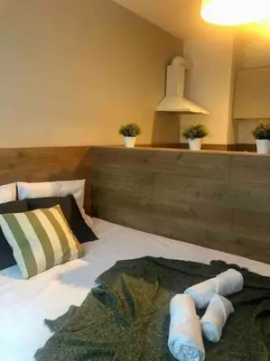 a bedroom with a bed with three pillows on it at BOOK High Rise Studio by Cosher in Sofia