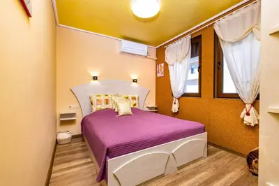 a bedroom with a purple bed in a room at Central Park Apartment Dragan Tsankov in Plovdiv
