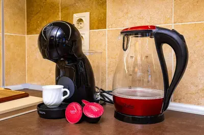a coffee maker sitting on a counter next to a cup at Central Park Apartment Dragan Tsankov in Plovdiv