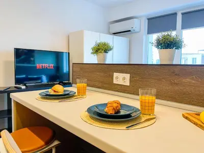 a table with two plates of food and glasses of orange juice at High Rise Studio by Cosher in Sofia