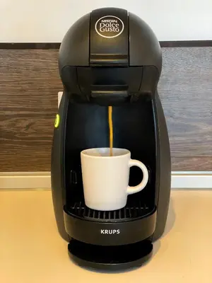 a coffee maker is making a cup of coffee at High Rise Studio by Cosher in Sofia