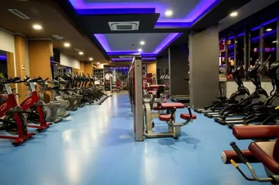 a gym with a lot of treadmills and exercise bikes at High Rise Studio by Cosher in Sofia
