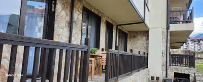 a building with windows and a wooden fence at Guest Suite in Bansko