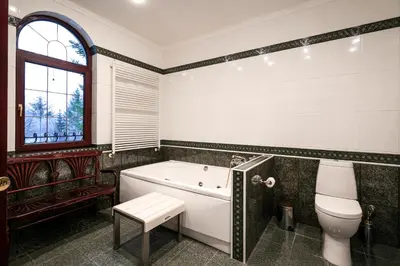a bathroom with a tub and a toilet at AMARI PARK Residence in Golyama Zhelyazna