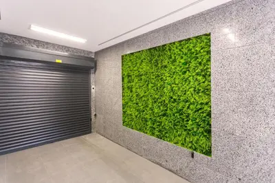 a green wall in a room with a garage at Relax Apartment in Sofia