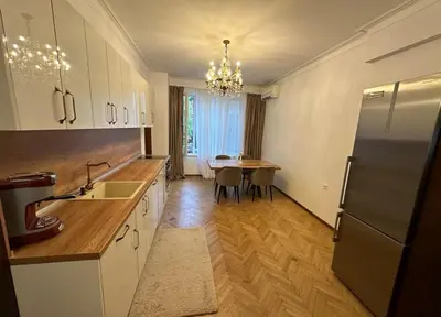 a kitchen with a refrigerator and a dining table at Apartament 86 in Sofia
