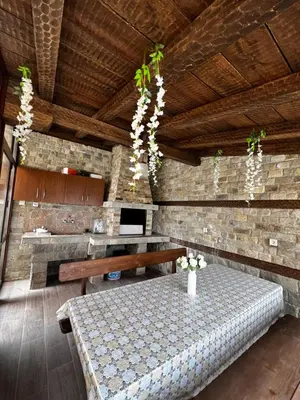 a dining room with a table and a bench at Villa Garden in Kremen