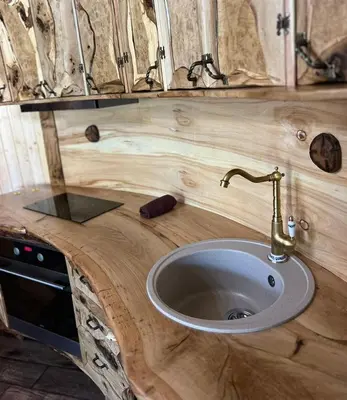 a wooden counter with a sink in a bathroom at Приказната къщичка на Смърфовете in Krayni Dol