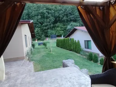 a view from the window of a house with a yard at Приказната къщичка на Смърфовете in Krayni Dol