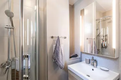 a bathroom with a sink and a shower at Aristocratic apartment with a parking spot in Sofia