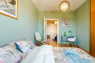 a bedroom with a bed and a desk in it at ART-ament, a unique central flat in Sofia