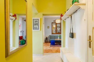 a hallway with a mirror and a living room at ART-ament, a unique central flat in Sofia