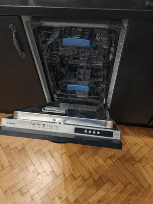 an open laptop computer sitting on a wooden floor at Apartament 87 in Sofia