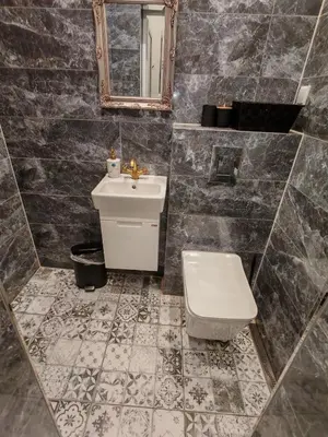 a bathroom with a sink and a toilet and a mirror at Apartament 87 in Sofia