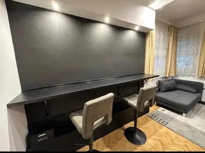a large black piano with two chairs and a couch at Apartament 87 in Sofia