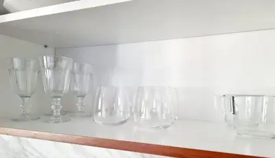 a row of empty glasses sitting on a counter at Studio Vihren 11,Bansko in Bansko