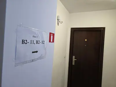 a room with a clock on the wall next to a door at Studio Vihren 11,Bansko in Bansko
