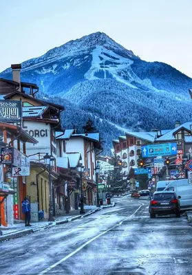 a street in a town with a mountain in the background at Studio Vihren 11,Bansko in Bansko