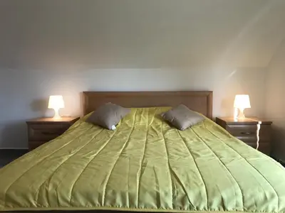 a bedroom with a green bed with two lamps at TOP CENTER STUDIO - the NEST by Flat Mаnager in Sofia