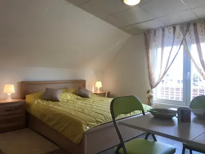 a bedroom with a bed and a table with chairs at TOP CENTER STUDIO - the NEST by Flat Mаnager in Sofia
